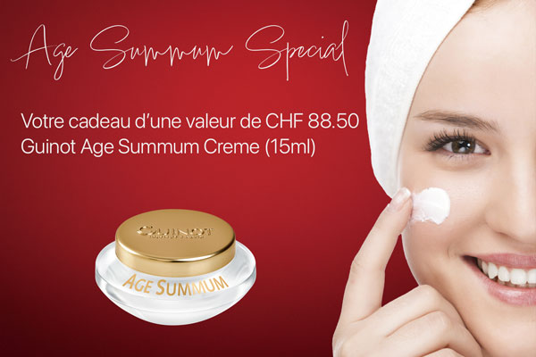 Guinot Age Summum Spécial — femme souriante appliquant une crème, présentant le pot Guinot Age Summum 15 ml offert comme cadeau d’une valeur de CHF 88.50.
